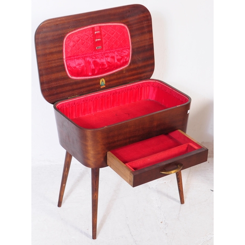 617 - Two mid 20th century retro teak sewing tables. To include example upholstered in a mustard moquette ... 