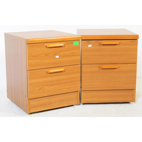 621 - British Modern Design - A pair of retro mid 20th century teak bedside cabinets. Each having a bank o... 