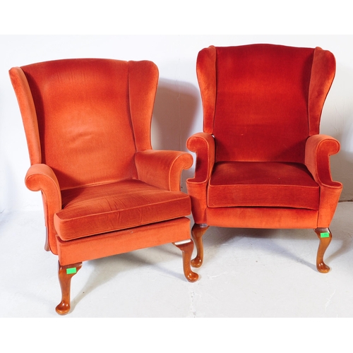 653 - Parker Knoll - Two retro mid 20th century Parker Knoll wing back armchairs upholstered in a red velv... 