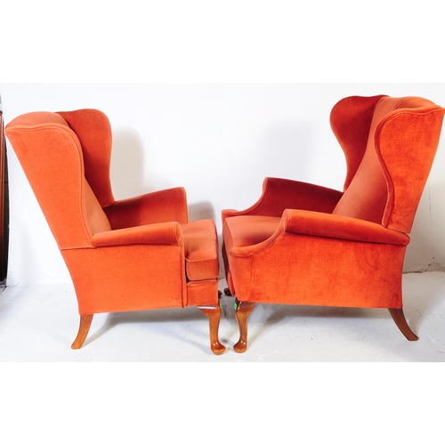 653 - Parker Knoll - Two retro mid 20th century Parker Knoll wing back armchairs upholstered in a red velv... 