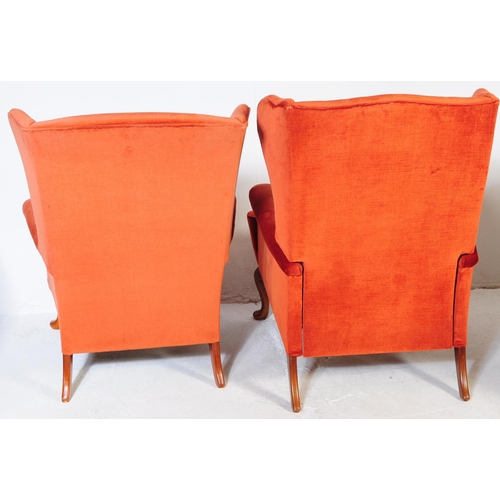 653 - Parker Knoll - Two retro mid 20th century Parker Knoll wing back armchairs upholstered in a red velv... 
