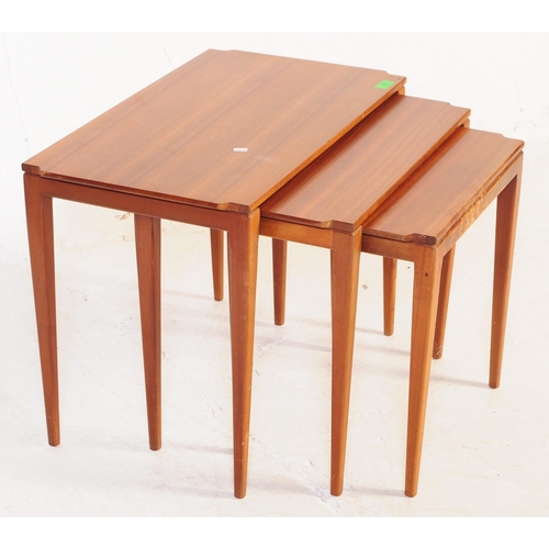 664 - A mid 20th century walnut nest of tables. Of rectangular form with shaped corners, square tapering. ... 