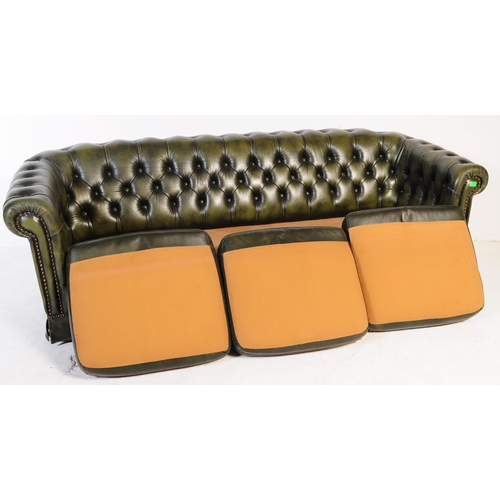 669 - A late 20th century button backed three seater sofa settee couch with arm chair in a chesterfield st... 