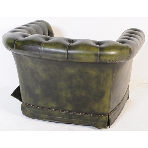 669 - A late 20th century button backed three seater sofa settee couch with arm chair in a chesterfield st... 