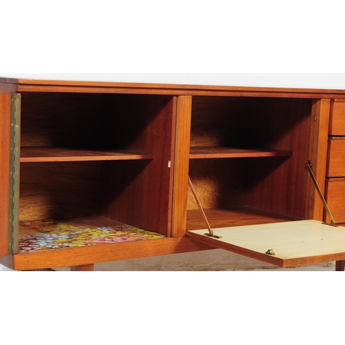 671 - A retro mid 20th century teak sideboard credenza by Beautility. Of rectangular form with a bank of t... 