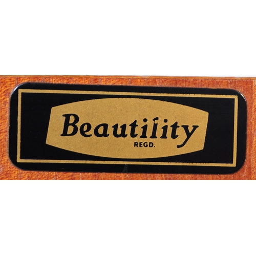 671 - A retro mid 20th century teak sideboard credenza by Beautility. Of rectangular form with a bank of t... 