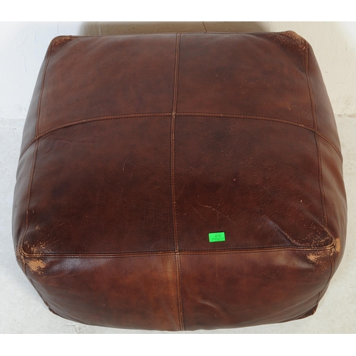 674 - A large contemporary brown leather stitched pouffe - lazy cushion. Of large square form with brown l... 