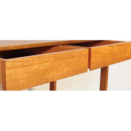 681 - British Modern Design - A mid 20th century teak writing desk / side table. The desk having twin draw... 