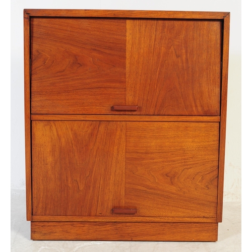 689 - A mid century walnut twin door filing cabinet. The desk raised on a plinth base with pedestal having... 