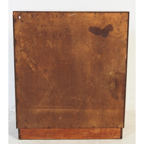 689 - A mid century walnut twin door filing cabinet. The desk raised on a plinth base with pedestal having... 