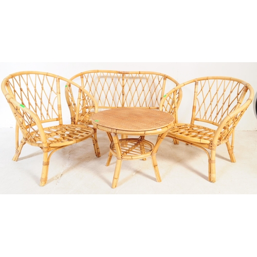 691 - A retro 20th century bamboo and cane suite. The set comprising a two seater sofa, two armchairs and ... 