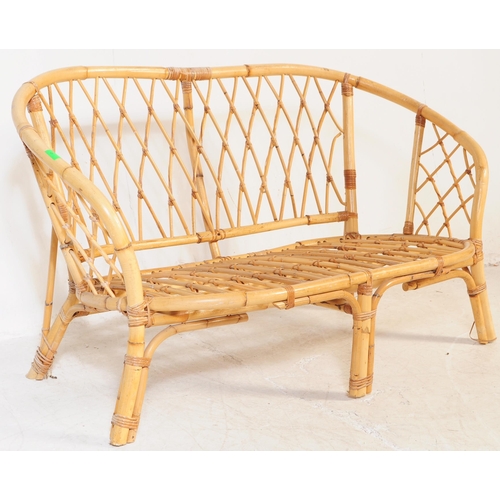 691 - A retro 20th century bamboo and cane suite. The set comprising a two seater sofa, two armchairs and ... 