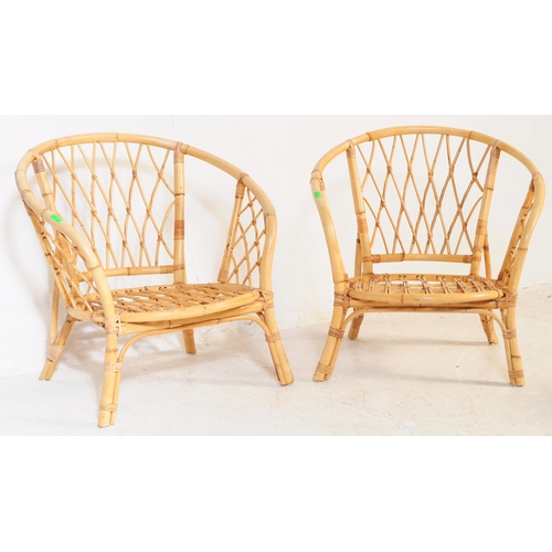 691 - A retro 20th century bamboo and cane suite. The set comprising a two seater sofa, two armchairs and ... 