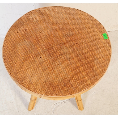 691 - A retro 20th century bamboo and cane suite. The set comprising a two seater sofa, two armchairs and ... 