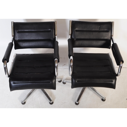 698 - A pair of vintage mid 20th century metal and leatherette chrome office swivel desk chairs. Having a ... 