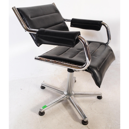 698 - A pair of vintage mid 20th century metal and leatherette chrome office swivel desk chairs. Having a ... 