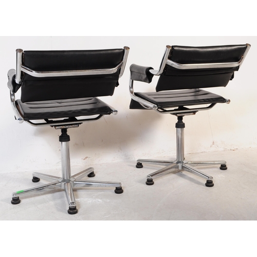 698 - A pair of vintage mid 20th century metal and leatherette chrome office swivel desk chairs. Having a ... 