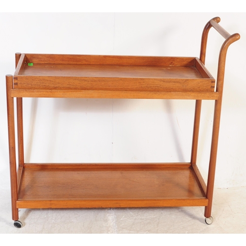 693 - A mid 20th century Danish inspired teak butlers serving hostess trolley. The trolley having shaped h... 