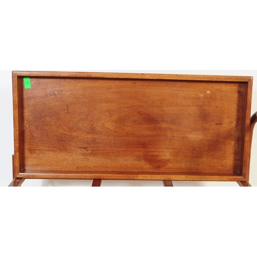 693 - A mid 20th century Danish inspired teak butlers serving hostess trolley. The trolley having shaped h... 