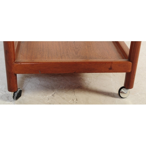 693 - A mid 20th century Danish inspired teak butlers serving hostess trolley. The trolley having shaped h... 