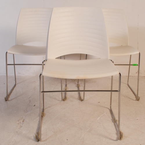 696 - Frovi - A set of three mid 20th century canteen / bistro / café dining chairs. Having moulded white ... 