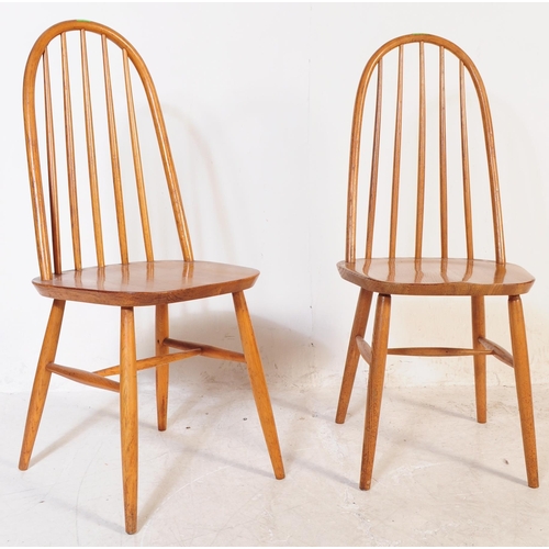 702 - A pair of mid 20th century vintage beech and elm dining / kitchen chairs. In the manner of Ercol Qua... 