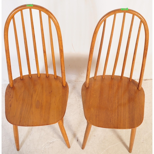 702 - A pair of mid 20th century vintage beech and elm dining / kitchen chairs. In the manner of Ercol Qua... 