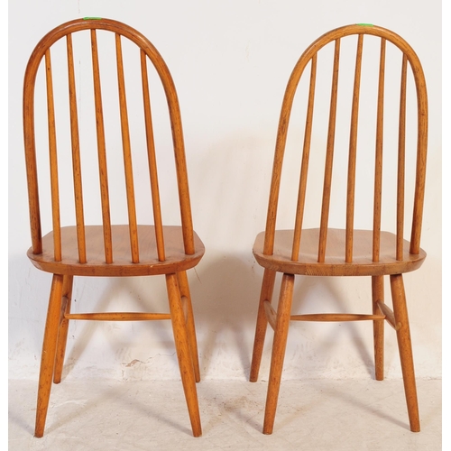 702 - A pair of mid 20th century vintage beech and elm dining / kitchen chairs. In the manner of Ercol Qua... 