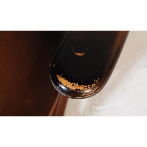 654 - Ercol Furniture - A vintage 20th century dark elm stick back Windsor rocking chair. Arched back rest... 