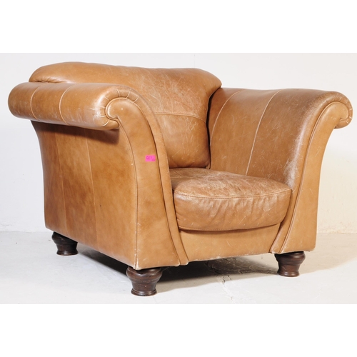 655 - A 20th Century beige / brown leather three seater sofa settee and matching arm chair. Having scrolle... 