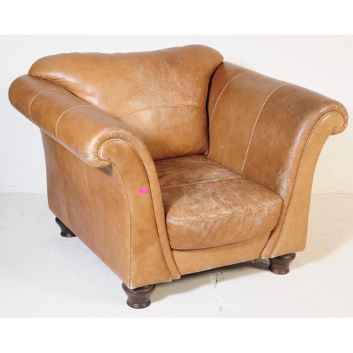 655 - A 20th Century beige / brown leather three seater sofa settee and matching arm chair. Having scrolle... 