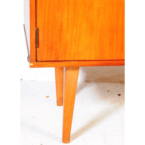 659 - British Modern Design - A mid 20th century teak wood sideboard credenza. Of rectangular form  compri... 