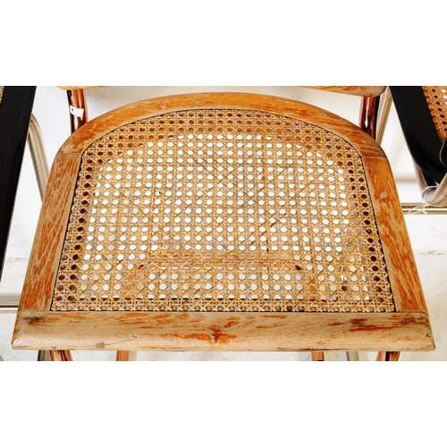 670 - A set of three retro 20th century oak & rose gold chrome cantilever chairs. Each chair having oak se... 