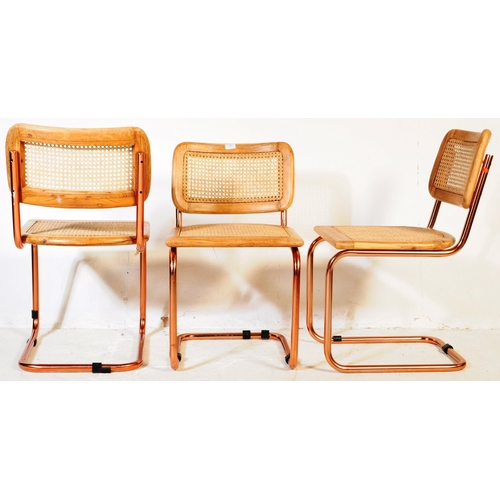 670 - A set of three retro 20th century oak & rose gold chrome cantilever chairs. Each chair having oak se... 