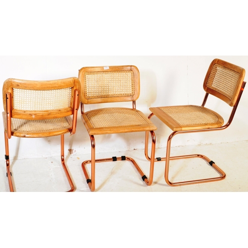 670 - A set of three retro 20th century oak & rose gold chrome cantilever chairs. Each chair having oak se... 