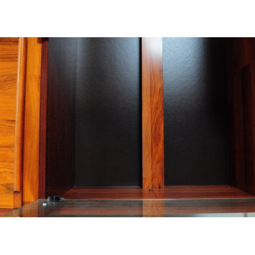 632 - A 20th century Belgium fruit wood wall unit comprising of a series of glazed and fall front cabinets... 