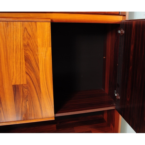 632 - A 20th century Belgium fruit wood wall unit comprising of a series of glazed and fall front cabinets... 