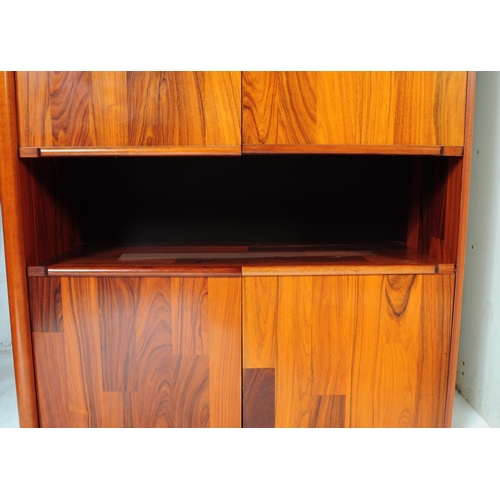 632 - A 20th century Belgium fruit wood wall unit comprising of a series of glazed and fall front cabinets... 