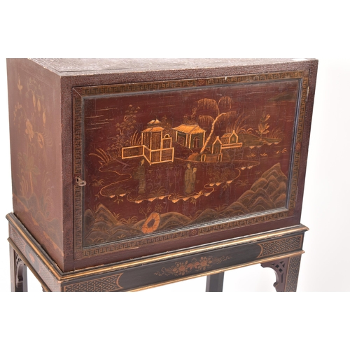 102 - A 19th century Chinoiserie cabinet on stand. The upper cupboard section having a single panelled doo... 