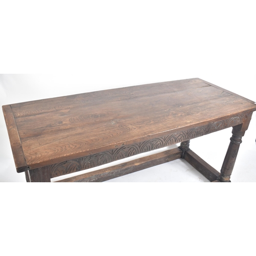 111 - A 17th century English oak refectory dining table. Raised on turned legs with low peripheral oak str... 