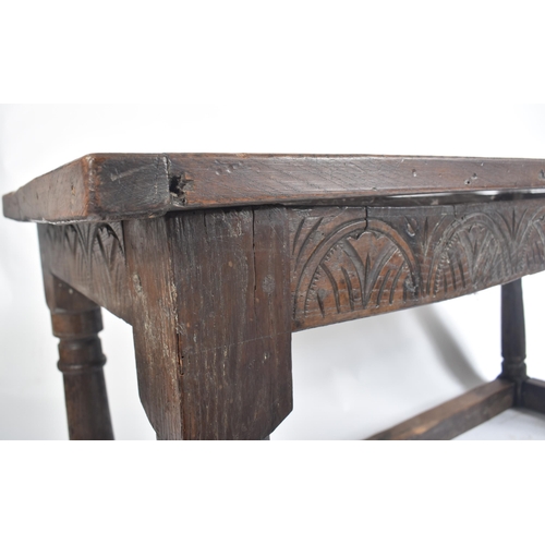 111 - A 17th century English oak refectory dining table. Raised on turned legs with low peripheral oak str... 