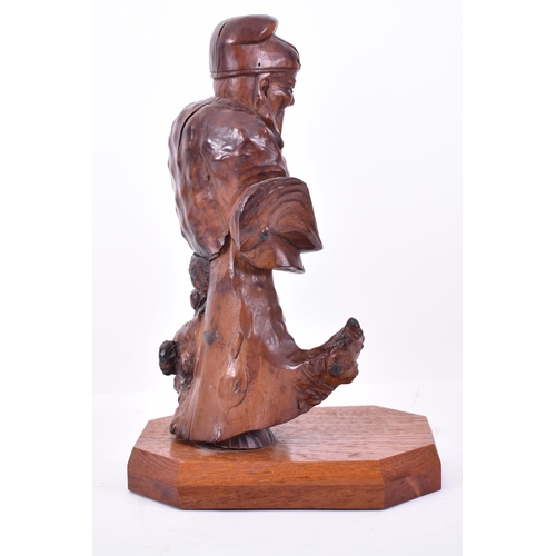 114 - A 20th century Chinese hand carved root wood deity of Prosperity figure. The sculpture modelled with... 