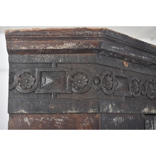 115 - A 17th century carved oak large corner cabinet. Raised on block feet with banded plinth to base. Abo... 