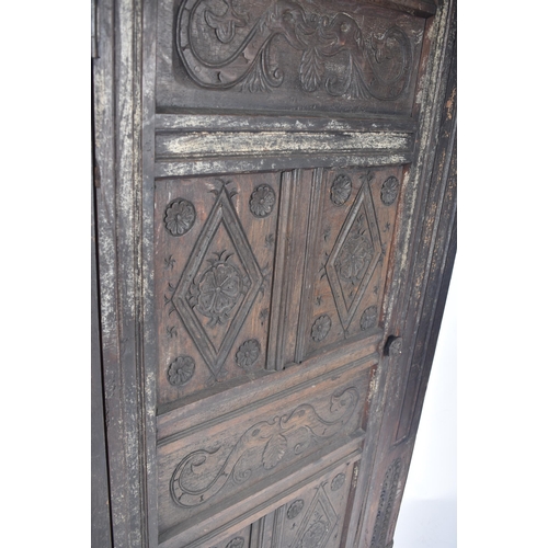 115 - A 17th century carved oak large corner cabinet. Raised on block feet with banded plinth to base. Abo... 