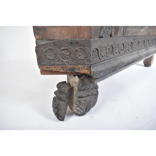 115 - A 17th century carved oak large corner cabinet. Raised on block feet with banded plinth to base. Abo... 