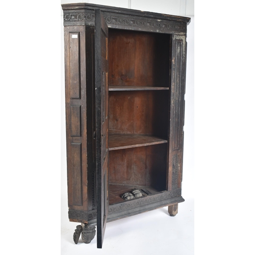 115 - A 17th century carved oak large corner cabinet. Raised on block feet with banded plinth to base. Abo... 