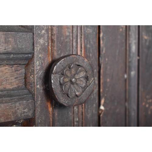 115 - A 17th century carved oak large corner cabinet. Raised on block feet with banded plinth to base. Abo... 