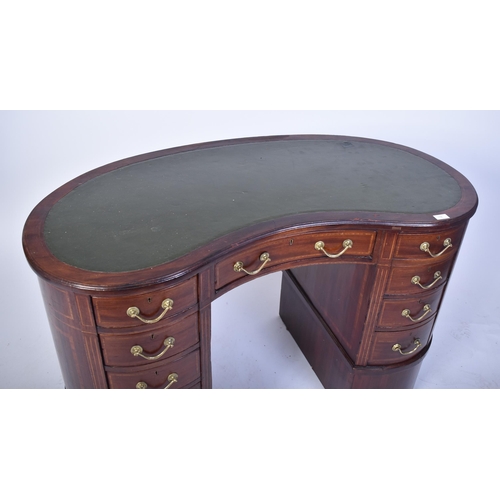 118 - An early 20th century Edwardian inlaid mahogany kidney shaped writing table desk. The desk having a ... 