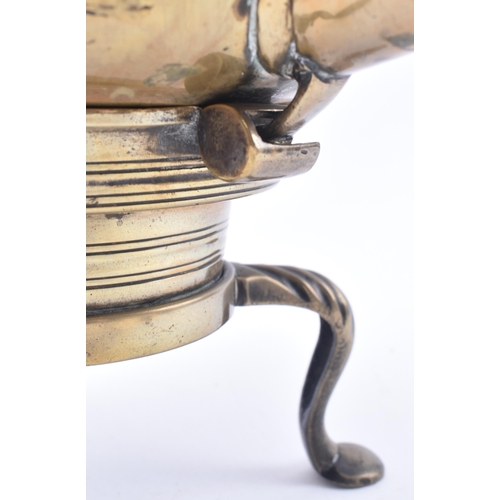 119 - An 18th century brass toddy kettle on stand. The kettle having a turned ebony baluster handle over a... 