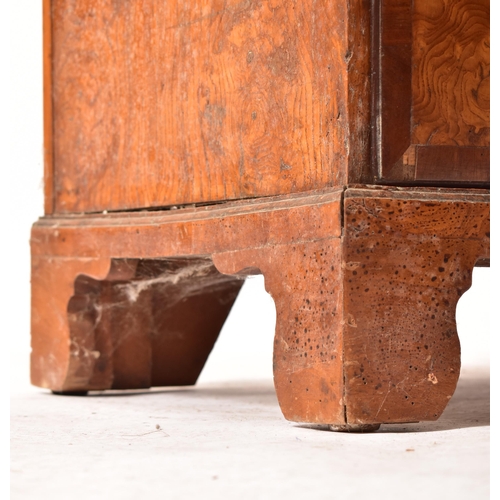 12 - An 18th century Queen Anne pollard oak crossbanded chest of drawers. Raised on bracket feet with sho... 